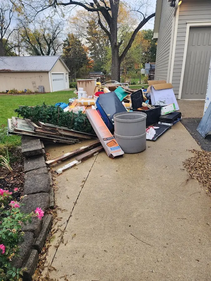 Dumpster being loaded with debris for Residential Dumpster Rental in Midway